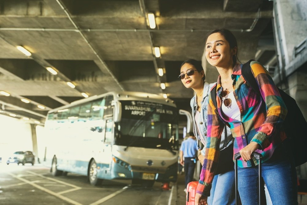 Two,Beautiful,Asian,Women,With,Suitcases,And,Backpacks,Returning,From